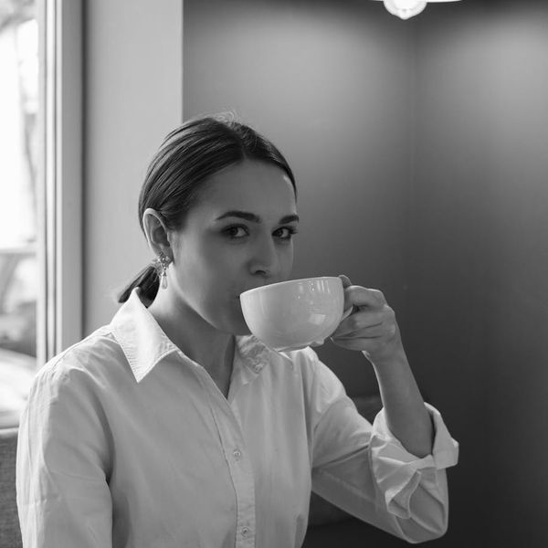 A person sitting calmly with a serene expression, morning light.