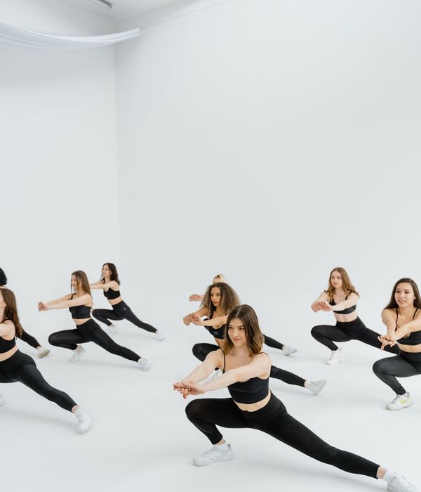 Woman performing a gentle stretching exercise in a modern studio.